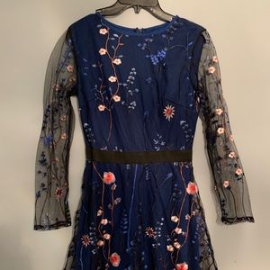 Navy dress with embroidered mesh over skirt.